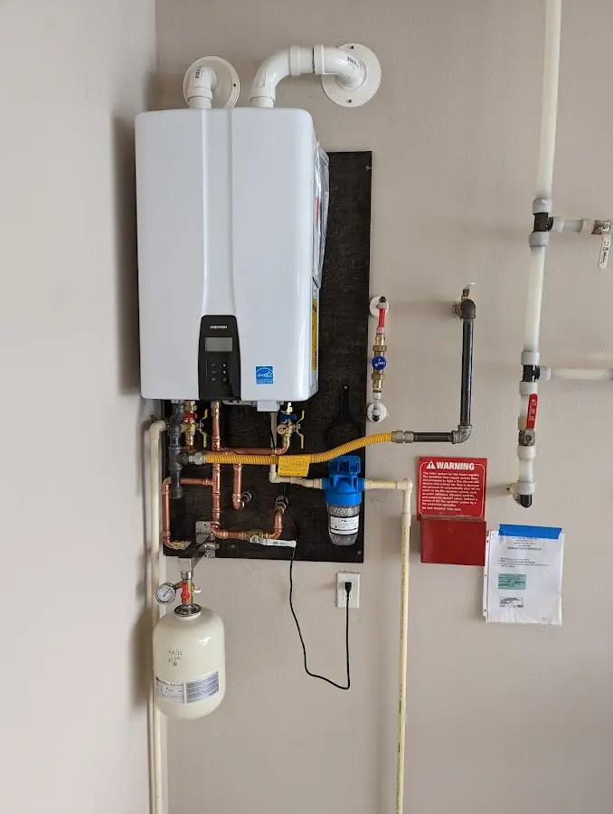 Professional plumber installing copper piping in a Fort Smith home